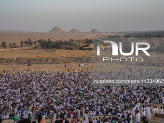 People are gathering to perform Eid prayers on one of the hills in the village of Abu Sir, in the middle of some of the ancient archaeologic...