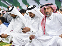 Muslim men are sitting before performing Eid al-Adha morning prayers at the Education City Stadium in Doha, Qatar, on June 16, 2024. Muslims...