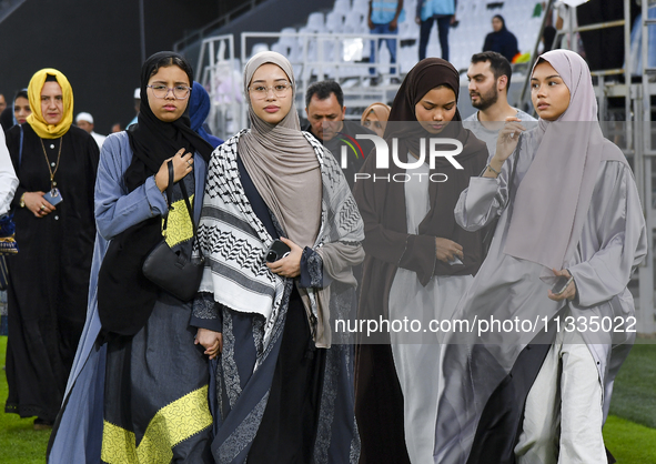 Muslim women are arriving for the Eid al-Adha morning prayers at the Education City Stadium on the first day of the Eid al-Adha holiday in D...