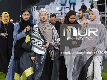 Muslim women are arriving for the Eid al-Adha morning prayers at the Education City Stadium on the first day of the Eid al-Adha holiday in D...