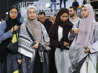 Muslim women are arriving for the Eid al-Adha morning prayers at the Education City Stadium on the first day of the Eid al-Adha holiday in D...