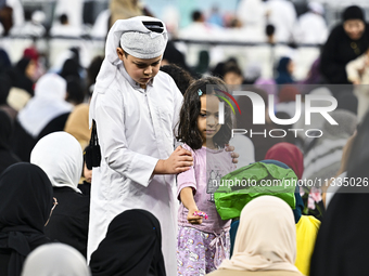 The children are celebrating after Eid al-Adha morning prayers inside Education City Stadium on the first day of the Eid al-Adha holiday in...