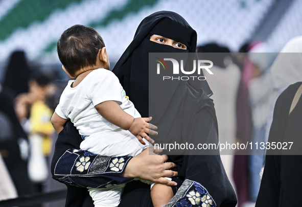 A Muslim woman is arriving for the Eid al-Adha morning prayers at the Education City Stadium on the first day of the Eid al-Adha holiday in...