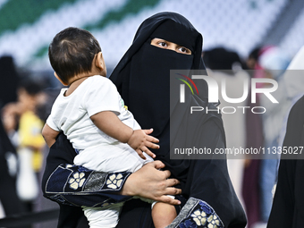 A Muslim woman is arriving for the Eid al-Adha morning prayers at the Education City Stadium on the first day of the Eid al-Adha holiday in...