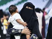 A Muslim woman is arriving for the Eid al-Adha morning prayers at the Education City Stadium on the first day of the Eid al-Adha holiday in...