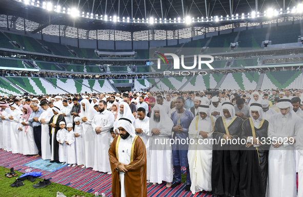 Worshipers are performing Eid al-Adha prayers at the Education City Stadium on the first day of the Eid al-Adha holiday in Doha, Qatar, on J...