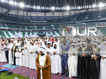 Worshipers are performing Eid al-Adha prayers at the Education City Stadium on the first day of the Eid al-Adha holiday in Doha, Qatar, on J...