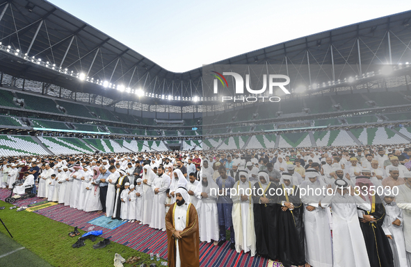 Worshipers are performing Eid al-Adha prayers at the Education City Stadium on the first day of the Eid al-Adha holiday in Doha, Qatar, on J...