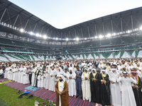 Worshipers are performing Eid al-Adha prayers at the Education City Stadium on the first day of the Eid al-Adha holiday in Doha, Qatar, on J...