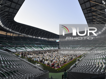 Worshipers are performing Eid al-Adha prayers at the Education City Stadium on the first day of the Eid al-Adha holiday in Doha, Qatar, on J...