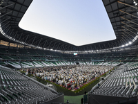 Worshipers are performing Eid al-Adha prayers at the Education City Stadium on the first day of the Eid al-Adha holiday in Doha, Qatar, on J...