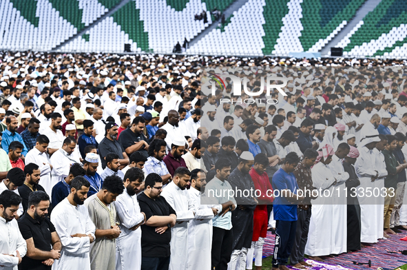 Worshipers are performing Eid al-Adha prayers at the Education City Stadium on the first day of the Eid al-Adha holiday in Doha, Qatar, on J...