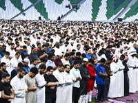 Worshipers are performing Eid al-Adha prayers at the Education City Stadium on the first day of the Eid al-Adha holiday in Doha, Qatar, on J...