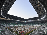 Worshipers are performing Eid al-Adha prayers at the Education City Stadium on the first day of the Eid al-Adha holiday in Doha, Qatar, on J...