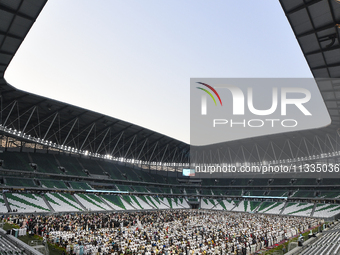 Worshipers are performing Eid al-Adha prayers at the Education City Stadium on the first day of the Eid al-Adha holiday in Doha, Qatar, on J...