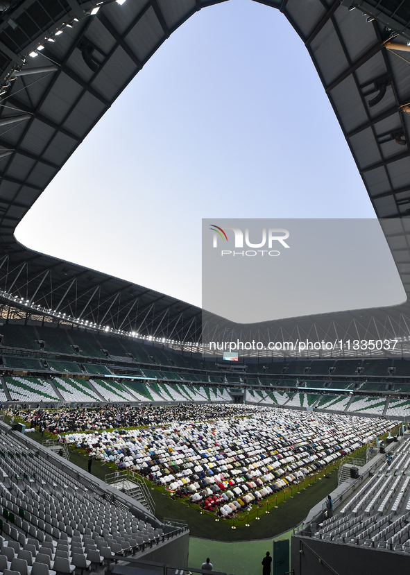 Worshipers are performing Eid al-Adha prayers at the Education City Stadium on the first day of the Eid al-Adha holiday in Doha, Qatar, on J...