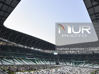 Worshipers are performing Eid al-Adha prayers at the Education City Stadium on the first day of the Eid al-Adha holiday in Doha, Qatar, on J...