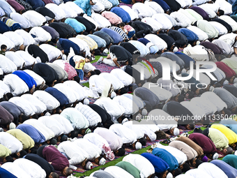 Worshipers are performing Eid al-Adha prayers at the Education City Stadium on the first day of the Eid al-Adha holiday in Doha, Qatar, on J...