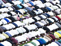 Worshipers are performing Eid al-Adha prayers at the Education City Stadium on the first day of the Eid al-Adha holiday in Doha, Qatar, on J...