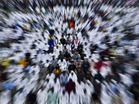 Worshipers are performing Eid al-Adha prayers at the Education City Stadium on the first day of the Eid al-Adha holiday in Doha, Qatar, on J...