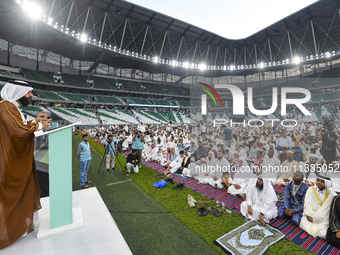 A Qatari imam Ahmed Al-Dosari is giving a sermon in front of worshipers after the Eid al-Adha prayer at the Education City Stadium on the fi...