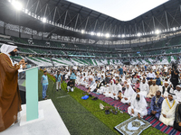 A Qatari imam Ahmed Al-Dosari is giving a sermon in front of worshipers after the Eid al-Adha prayer at the Education City Stadium on the fi...