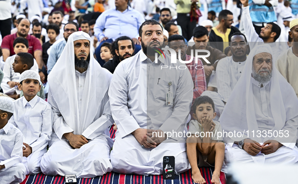 Worshipers are performing Eid al-Adha prayers at the Education City Stadium on the first day of the Eid al-Adha holiday in Doha, Qatar, on J...