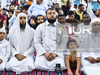 Worshipers are performing Eid al-Adha prayers at the Education City Stadium on the first day of the Eid al-Adha holiday in Doha, Qatar, on J...