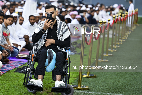 Worshipers are performing Eid al-Adha prayers at the Education City Stadium on the first day of the Eid al-Adha holiday in Doha, Qatar, on J...