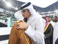 People are greeting each other after performing the Eid al-Adha morning prayer at the Education City Stadium on the first day of the Eid al-...