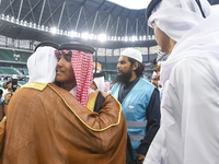 People are greeting each other after performing the Eid al-Adha morning prayer at the Education City Stadium on the first day of the Eid al-...