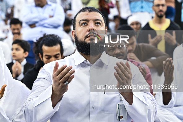 Worshipers are performing Eid al-Adha prayers at the Education City Stadium on the first day of the Eid al-Adha holiday in Doha, Qatar, on J...