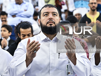 Worshipers are performing Eid al-Adha prayers at the Education City Stadium on the first day of the Eid al-Adha holiday in Doha, Qatar, on J...