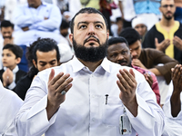 Worshipers are performing Eid al-Adha prayers at the Education City Stadium on the first day of the Eid al-Adha holiday in Doha, Qatar, on J...