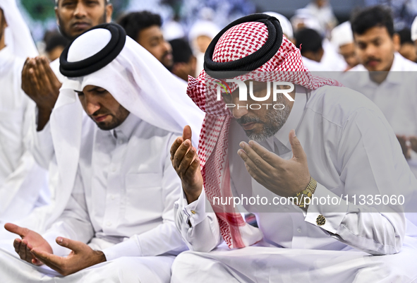 Worshipers are performing Eid al-Adha prayers at the Education City Stadium on the first day of the Eid al-Adha holiday in Doha, Qatar, on J...