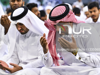 Worshipers are performing Eid al-Adha prayers at the Education City Stadium on the first day of the Eid al-Adha holiday in Doha, Qatar, on J...