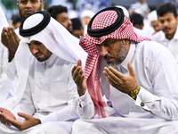 Worshipers are performing Eid al-Adha prayers at the Education City Stadium on the first day of the Eid al-Adha holiday in Doha, Qatar, on J...