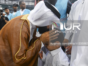 People are greeting each other after performing the Eid al-Adha morning prayer at the Education City Stadium on the first day of the Eid al-...