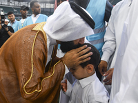 People are greeting each other after performing the Eid al-Adha morning prayer at the Education City Stadium on the first day of the Eid al-...