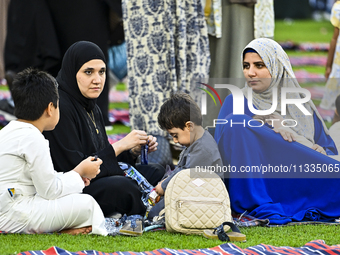 People are gathering after Eid al-Adha morning prayer at the Education City Stadium on the first day of the Eid al-Adha holiday in Doha, Qat...