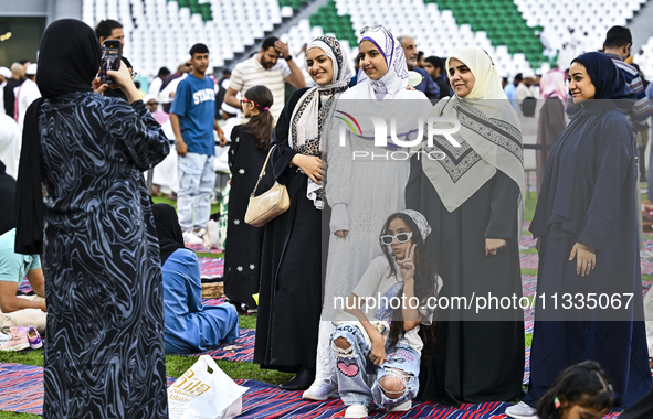 People are gathering after Eid al-Adha morning prayer at the Education City Stadium on the first day of the Eid al-Adha holiday in Doha, Qat...