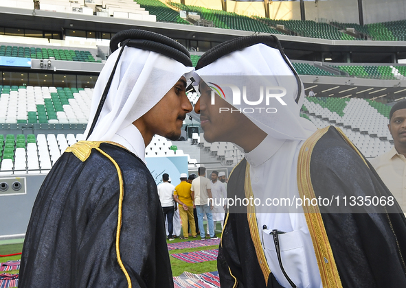 People are greeting each other after performing the Eid al-Adha morning prayer at the Education City Stadium on the first day of the Eid al-...