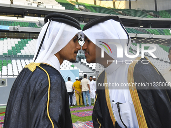 People are greeting each other after performing the Eid al-Adha morning prayer at the Education City Stadium on the first day of the Eid al-...