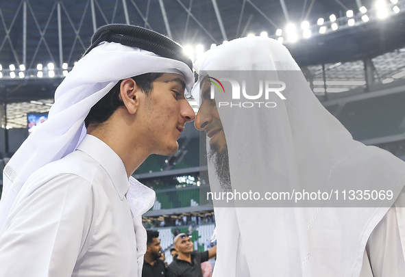 People are greeting each other after performing the Eid al-Adha morning prayer at the Education City Stadium on the first day of the Eid al-...