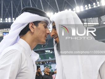 People are greeting each other after performing the Eid al-Adha morning prayer at the Education City Stadium on the first day of the Eid al-...