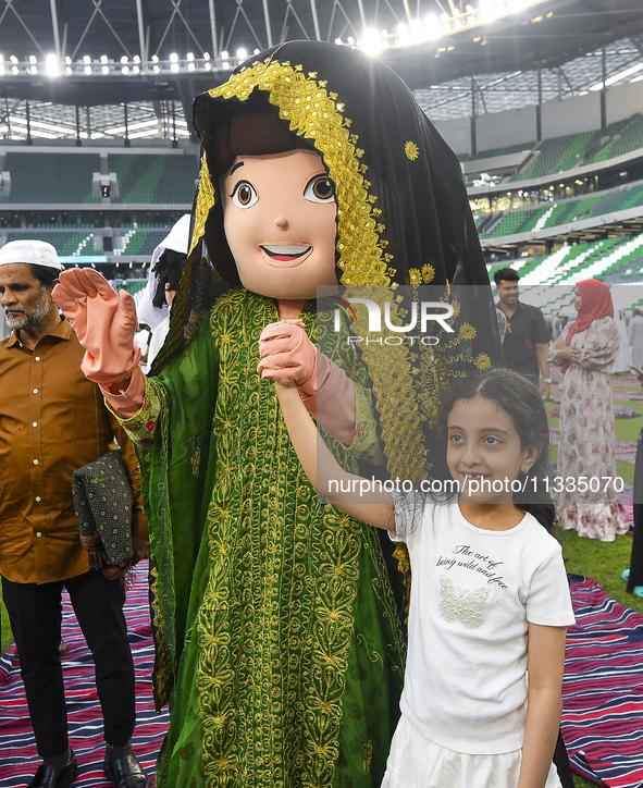 Children are celebrating after performing the Eid al-Adha morning prayer at the Education City Stadium on the first day of the Eid al-Adha h...