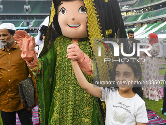 Children are celebrating after performing the Eid al-Adha morning prayer at the Education City Stadium on the first day of the Eid al-Adha h...