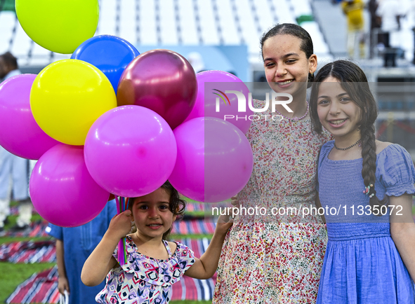 Children are celebrating after performing the Eid al-Adha morning prayer at the Education City Stadium on the first day of the Eid al-Adha h...