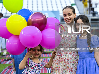 Children are celebrating after performing the Eid al-Adha morning prayer at the Education City Stadium on the first day of the Eid al-Adha h...