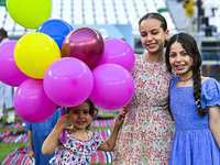 Children are celebrating after performing the Eid al-Adha morning prayer at the Education City Stadium on the first day of the Eid al-Adha h...